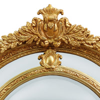Extremely ornate arched gold mirror with beveled panels.  This statement mirror would look amazing in a hallway, just opening up the space and adding a luxurious air to your entryway. In a living room to flash out light and give the illusion of extra space.  Stunning rococo revival style with swags and medallions to the crown and heavily ornamented frame. The gilding is a beautifully opulent gilt leaf giving the frame an opulent lustre.  
There is no room in the house that would not ben