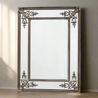 Silver gilt coloured, bevelled glass panels and ornate corners give this beautiful mirror a really luxurious feel.  