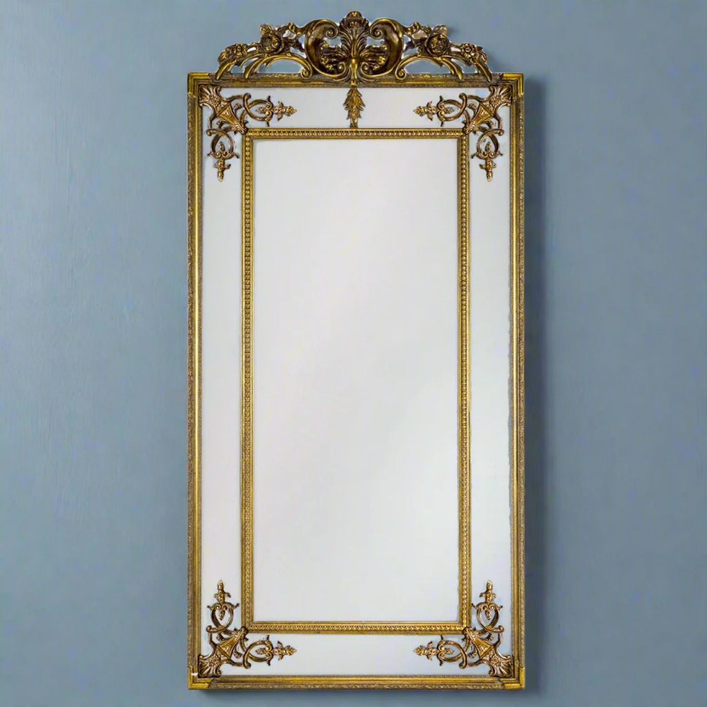 Stunning panelled gold mirror with decorative crown. The bevelled edges on the panels in this magnificent mirror spreads light in any room.   This is the slimmer version or our massive French mirror, tall, elegant and perfect in your bedroom or at the end of a corridor to add a light and space.