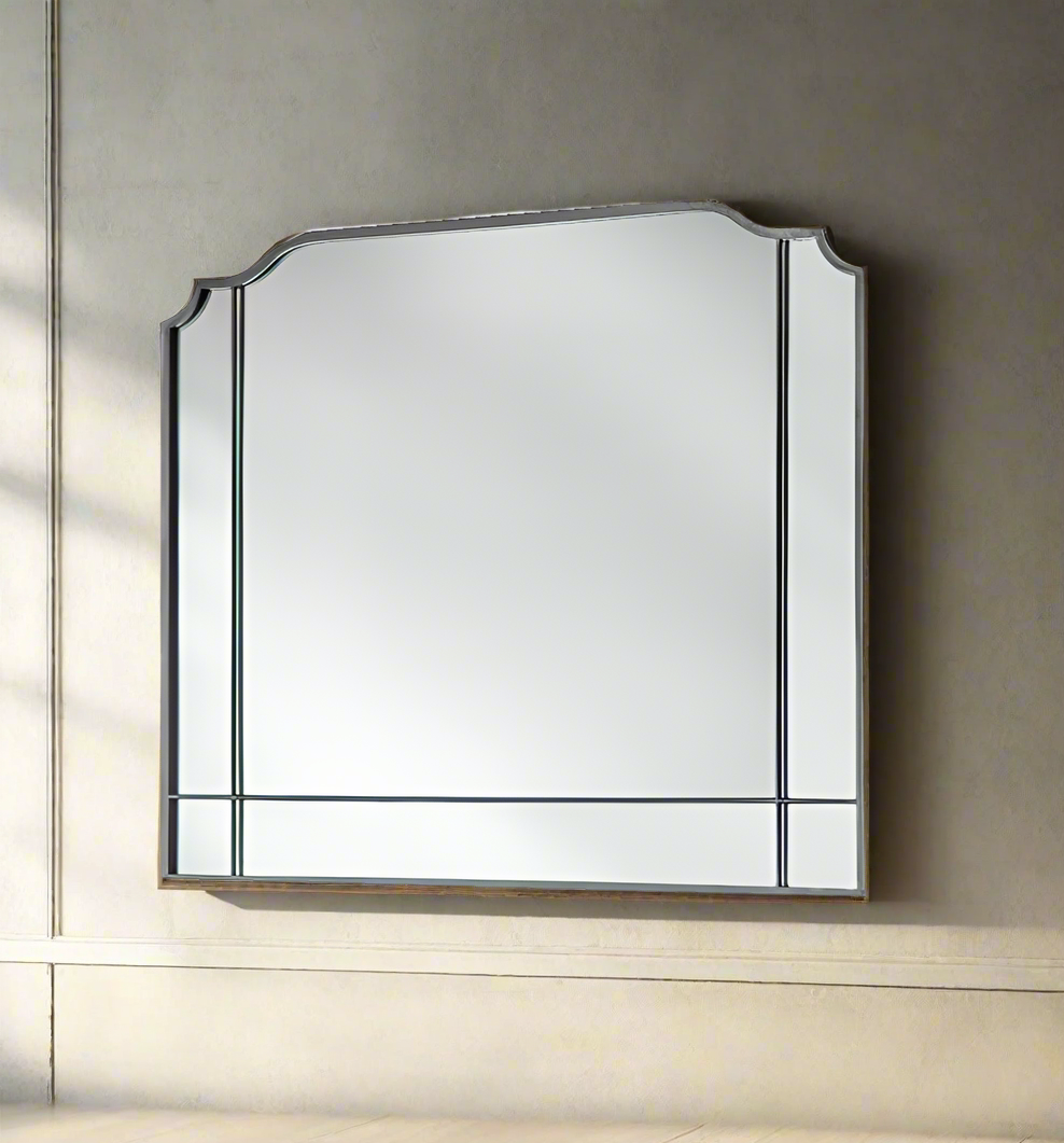 Shaped  metal paneled overmantle shaped mirror.   This 'art deco' style mirror is perfect over a period fireplace or on any wall in your space. Large enough to add space and light to any room.  An overmantle in a metal finish would look great over a marble, metal or wooden fireplace.  The panels at the side and base add to the period look of this mirror, large enough to reflect a lot of light into the room. It's well worth checking out all the different Overmantle mirrors on our web