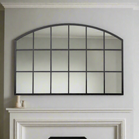 Low, wide window mirror, perfect overmantle size, adding space and perspective to any room. Arched metal framed window mirror placed over a fireplace or mantle.