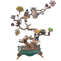 Bronze sculptured branches in this candelabra hold little porcelain birds and flowers and on the branches there are three bronze candleholders.  A mixture of greens, pinks, yellow and blue, the colourful tree is set on a rectangular green porcelain base on small bronze feet. The most decorative candleholder would look stunning as a centrepiece or set on a beautiful piece of furniture to add interest and a luxurious touch to your interior.