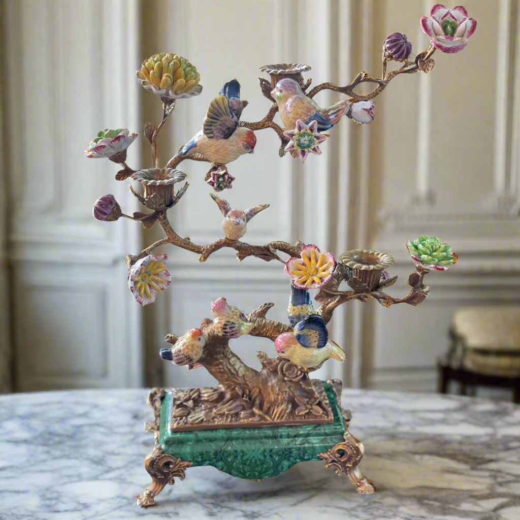 Bronze sculptured branches in this candelabra hold little porcelain birds and flowers and on the branches there are three bronze candleholders.  A mixture of greens, pinks, yellow and blue, the colourful tree is set on a rectangular green porcelain base on small bronze feet. The most decorative candleholder would look stunning as a centrepiece or set on a beautiful piece of furniture to add interest and a luxurious touch to your interior.