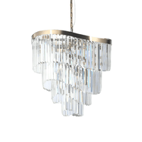 A four tiered crystal prism chandelier on a curved satin brass frame the full drop of the chandelier is perfect for a stairwell, would be a statement.