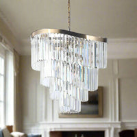 A four tiered crystal prism chandelier on a curved satin brass frame the full drop of the chandelier is perfect for a stairwell, would be a statement.