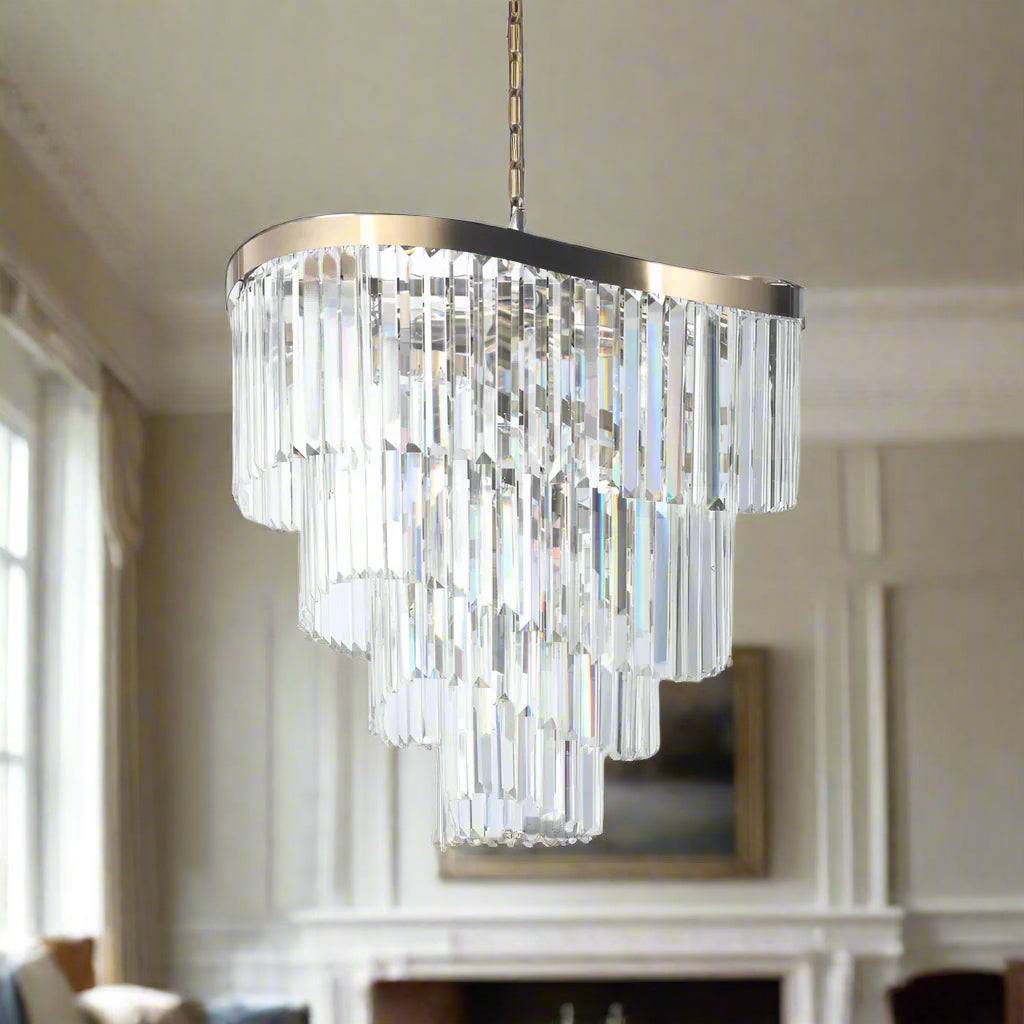A four tiered crystal prism chandelier on a curved satin brass frame the full drop of the chandelier is perfect for a stairwell, would be a statement.