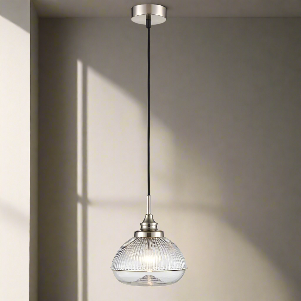 A ribbed glass pendant on beautifully designed satin nickel fittings. The hanging glass fitting with satin nickle metal accents would be a perfect over a kitchen island.