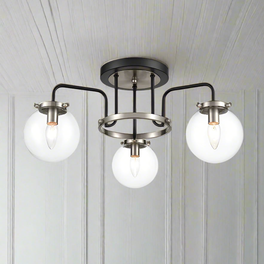 3 Glass globe semi- flush industrial style light, set in nickel metal frame. This semi-flush pendant it in a black and nickle finish so would look just as stunning in a contemporary home.