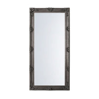 A classic silver leaner mirror with period carved decoration, showing a rectangular frame with intricate details.