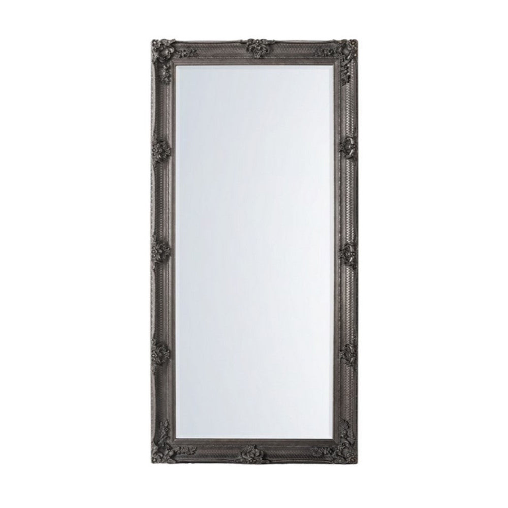 A classic silver leaner mirror with period carved decoration, showing a rectangular frame with intricate details.