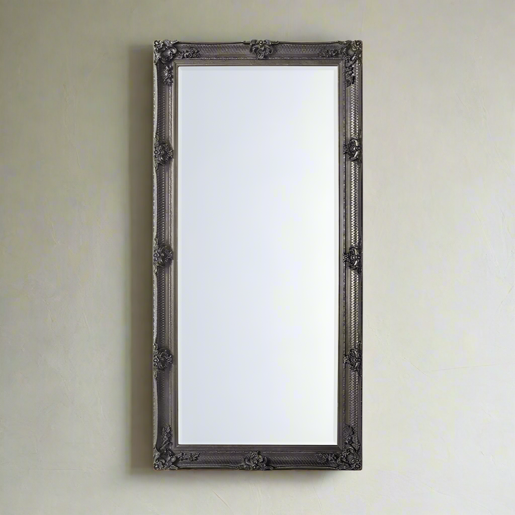 Classic silver leaner mirror with period carved decoration.  A large roccoco framed mirror in silver with a classic ornate look.  A great hall mirror, this size will add a lot of light and pespective to any entryway.   Great in a dressing room, leaning or hanging on a wall. In your living room to add statement glamour to your room.