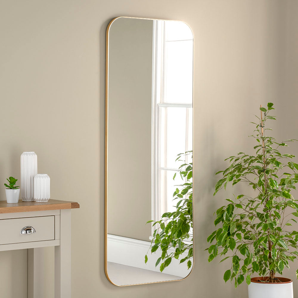 A wonderfully slimline minimal gold gilt frame with lots of mirror glass gives this mirror a contemporary sleek feel.   Beautifully curved corners soften your walls.  Add glamour and extra light to your room with this piece that does all the work for you.  Minimal mirror for maximum impact.
Available in gold, silver and black.  Please inquire for details. 
These mirrors are made in our UK workshop so please allow 3 weeks for production.  If required sooner, please do l