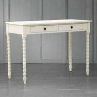 A pine desk painted in soft ivory with turned leg detail. Such a simple but so useful desk or dressing table in a Ivory paint finish The legs are turned in a spiral decoration. This piece of furniture would look perfect in a bedroom as a desk, in a living room or hall as a console.