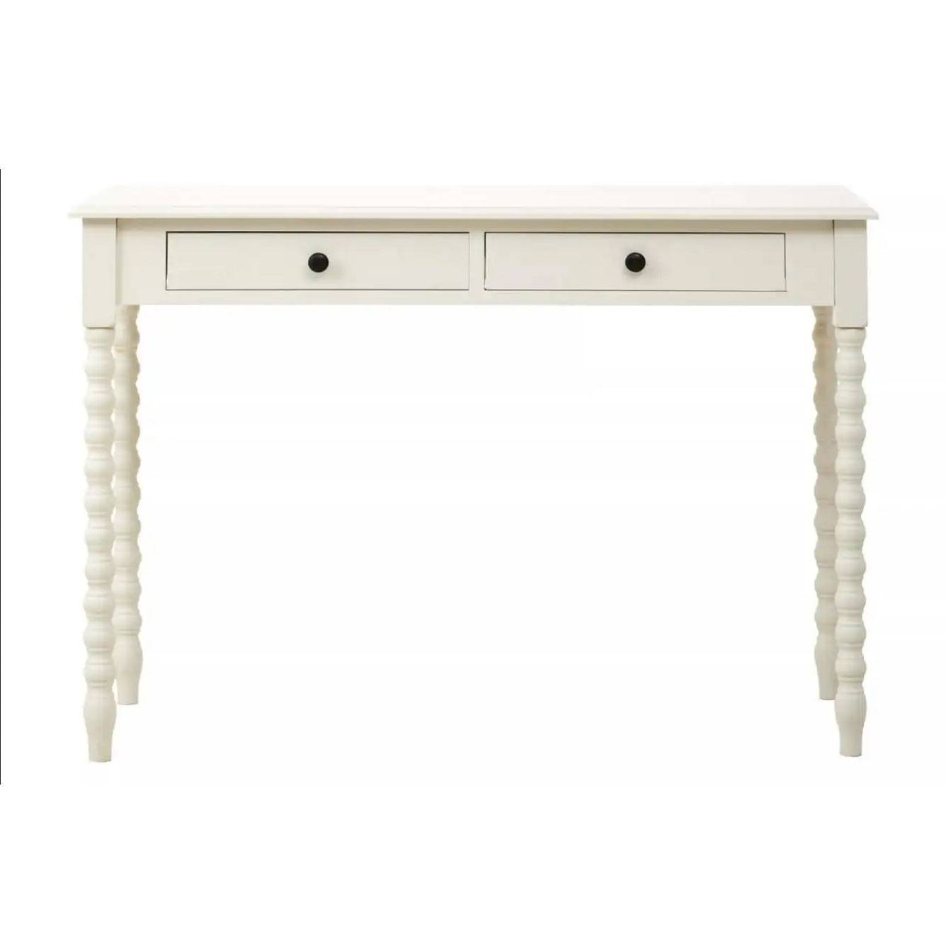 A pine desk painted in soft ivory with turned leg detail. Such a simple but so useful desk or dressing table in a Ivory paint finish The legs are turned in a spiral decoration. This piece of furniture would look perfect in a bedroom as a desk, in a living room or hall as a console.