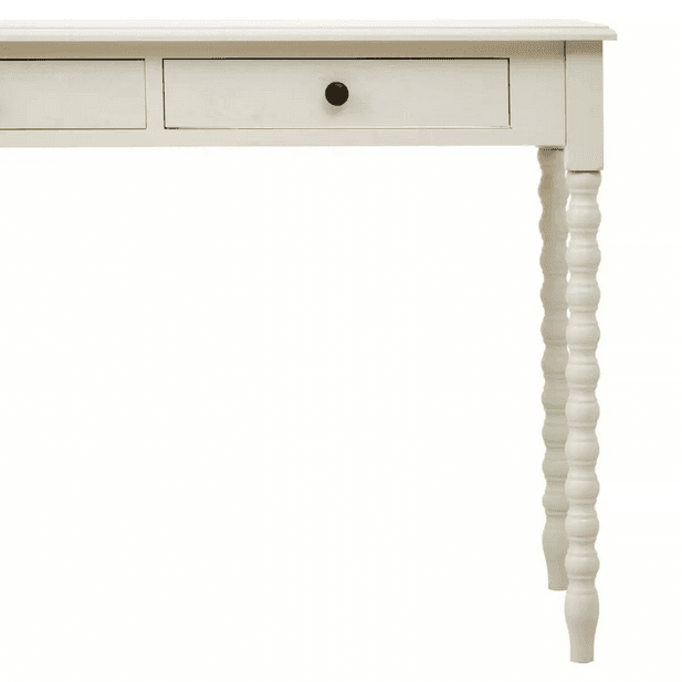A pine desk painted in soft ivory with turned leg detail. Such a simple but so useful desk or dressing table in a Ivory paint finish The legs are turned in a spiral decoration. This piece of furniture would look perfect in a bedroom as a desk, in a living room or hall as a console.