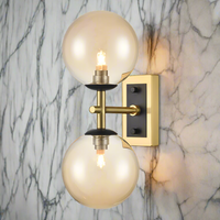 Stylish aged brass and matt black metal fixtures with two tinted glasses It creates an instant classy and elegant feel. With an IP Rating 44, it can be use in the bathroom transforming your space with a glamorous look.