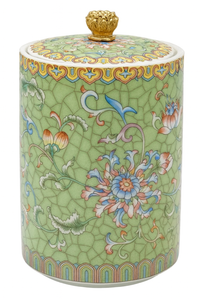 Handcrafted green ceramic scented candle jar with gold detailing and floral pattern, scented with warm amber, florals, and woods.