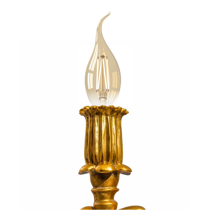 Gold cherub table light, perfectly formed cherubim hand outstretched holding a lamp.  The lamp looks best with the addition of a filament bulb to add a glow.  The lamp has a rococo decorative style working well in a luxurious bedroom, baroque styled living room - anywhere you need a touch of glamour.   So decorative but also perfectly functional.  