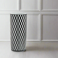 A stunning chequer designed black and white ceramic umbrella stand.  A beautiful addition to your hall. The outstanding black and white chequered pattern is definitely going to stand out in any hall, foyer or entryway. Superb umbrella storage in a glamorous ceramic stand. A striking visual contrast in any neutral painted room.  Crafted from high quality ceramic, the umbrella stand has a smooth, glossy finish to enhance the crispness of the design while the cylindrical shape offes ample space for m