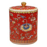 Handcrafted red ceramic scented candle jar with floral design and gold detailing, scented with Mission Fig and Jasmine.