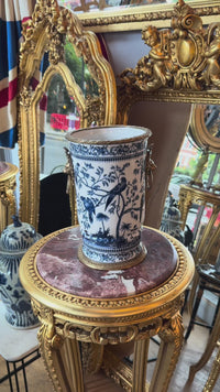This exquisite Bronze Porcelain Decorative Vase is functional as it is decorative,
Handcrafted in superior blue and white porcelain, this delicately weighted vase features intricate bird and foliage motifs.  Bold bronze lion head handle and detailed bronze accents reflect exceptional craftsmanship.  The aged porcelain body is delicately hand-painted which adds to its opulent appeal.
Ideal for living rooms, entryways, or as a centerpiece, this handcrafted vase is designed for as a lasting beauty,