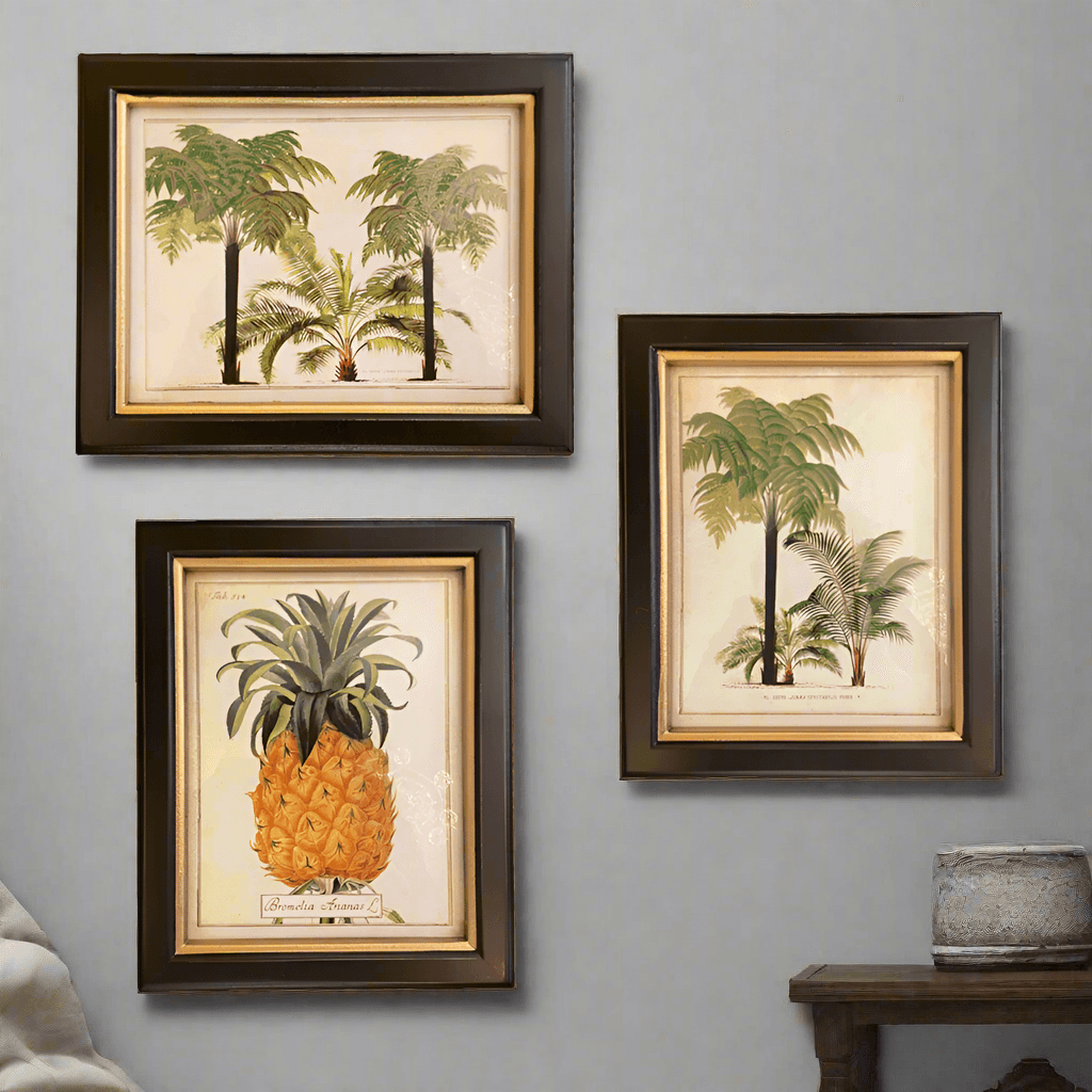 Set of three small vintage prints featuring palm trees and a pineapple in black frames, perfect for retro-themed wall decor.