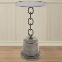 A tall side table with a round top and a chain stand connecting to a pedestal base, made of aluminium, displayed against a indoor background.