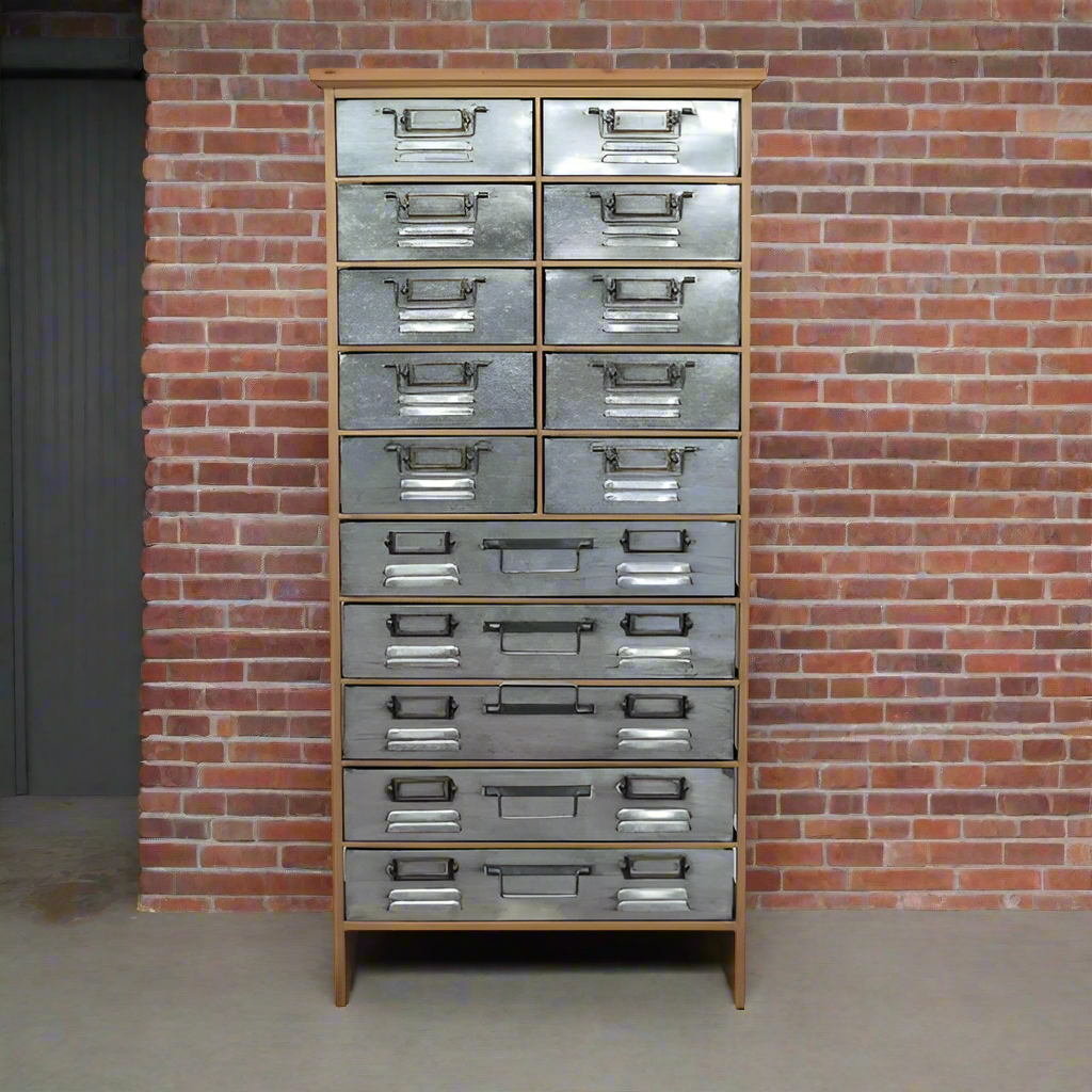 Amazing industrial back of drawers, wooden carcass with 10 smaller drawers over 5 larger drawers clad in metal, the epitome of industrial furniture. So useful with a designer edge to give a unique look in any space.  Set against a brick wall.