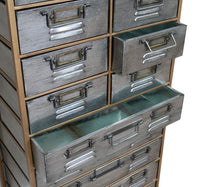Close up of 15 drawer chest, in steel and wood, On a white background.