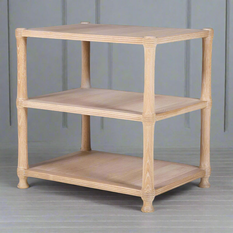 A really useful three tier side table in a beautiful pale oak colour.&nbsp; The three rectangular shelves are supported by four corner legs, which are subtly carved near the joints. Each tier provides open storage space, so practical in your living area.&nbsp; Great for use as a side table or as a small storage unit with its clean and versatile aesthetic it will work well in so many different interior styles.