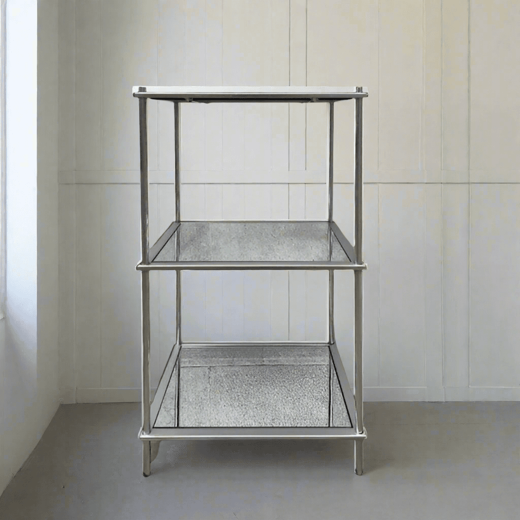 This silver leafed metal and mirrored glass three tiered shelf unit is perfect for upstyling any room while adding extra storage. A perfect piece to declutter and organise and your space. An highly versatile, attractive piece of furniture to elevate your space.