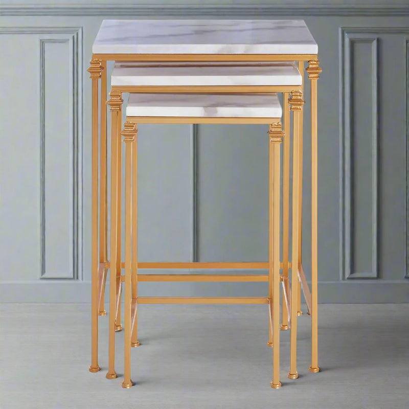 A luxurious nest of 3 marble topped tables, on a deep gold metal frame. The contrast between the cool white marble and the polished gilt metal of the legs adds to the luxe look of these tables.