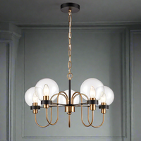 Five Clear glass globes on the five metal arms in antique gold on matte black, a stunning medium size statement light.&nbsp;&nbsp; Adjustable chain offers a long drop for this fitting. An extremely unusual fitting, suitable for a study, bedroom or smaller living room.


W: 57 cm&nbsp; H:&nbsp; Min: 52 cm &nbsp; Max: 139 cm