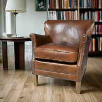 This is a classic leather armchair with a rich brown finish. The chair is upholstered in high-quality leather and has a slightly distressed finish.