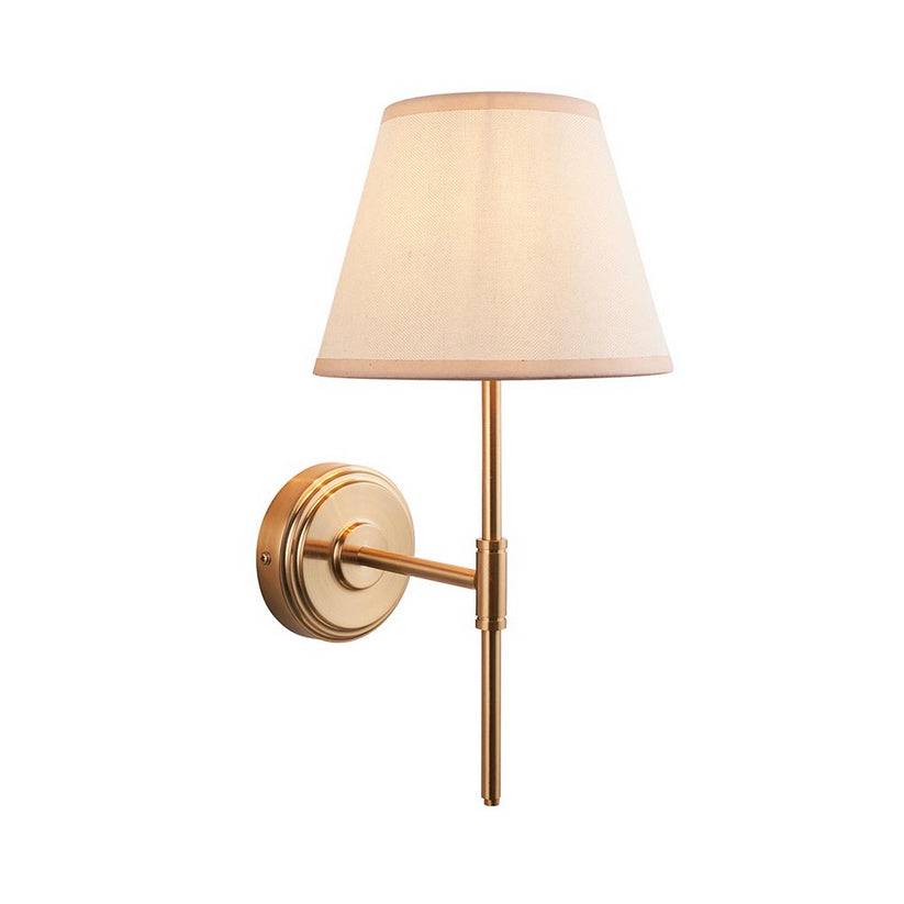 Very simple, classic shaded wall light in brushed aged brass. The neutral shade is a perfect addition, totally classic. This wall light is a great bedside lamp, situated on the wall