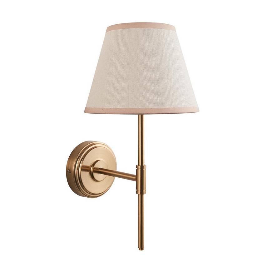 Very simple, classic shaded wall light in brushed aged brass. The neutral shade is a perfect addition, totally classic. This wall light is a great bedside lamp, situated on the wall