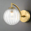 Stylish aged brass wall light with a clear ribbed glass. It creates an instant classy and elegant feel. With an IP Rating 44, it can be use in the bathroom transforming your space with a glamorous look.