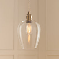 Tall clear glass pendant with brass fitting and black twisted flex.&nbsp; These are extra large glass pendants, perfect grouped over an island in the kitchen, on a stairwell or in a hall.