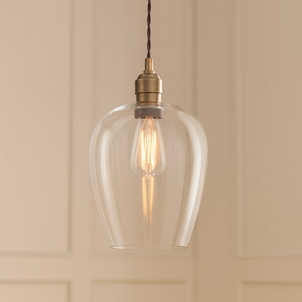 Tall clear glass pendant with brass fitting and black twisted flex.&nbsp; These are extra large glass pendants, perfect grouped over an island in the kitchen, on a stairwell or in a hall.