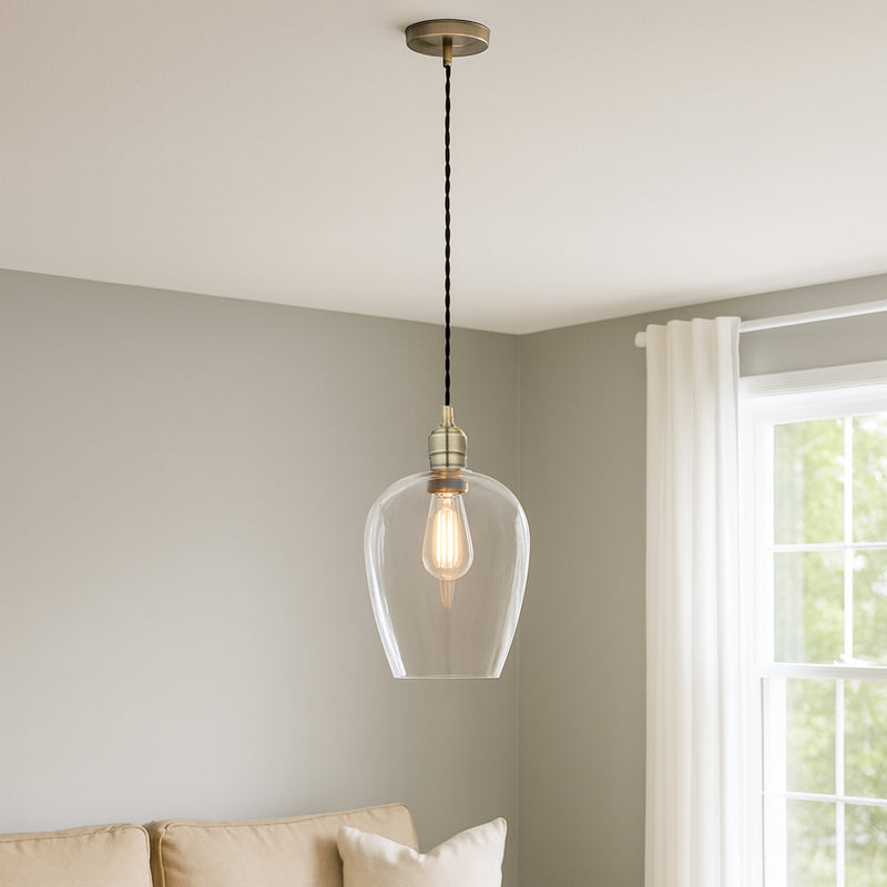 Tall clear glass pendant with brass fitting and black twisted flex.&nbsp; These are extra large glass pendants, perfect grouped over an island in the kitchen, on a stairwell or in a hall.