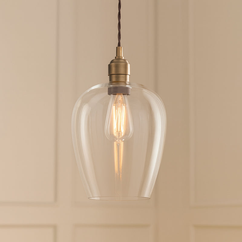 Tall clear glass pendant with brass fitting and black twisted flex.&nbsp; These are extra large glass pendants, perfect grouped over an island in the kitchen, on a stairwell or in a hall.