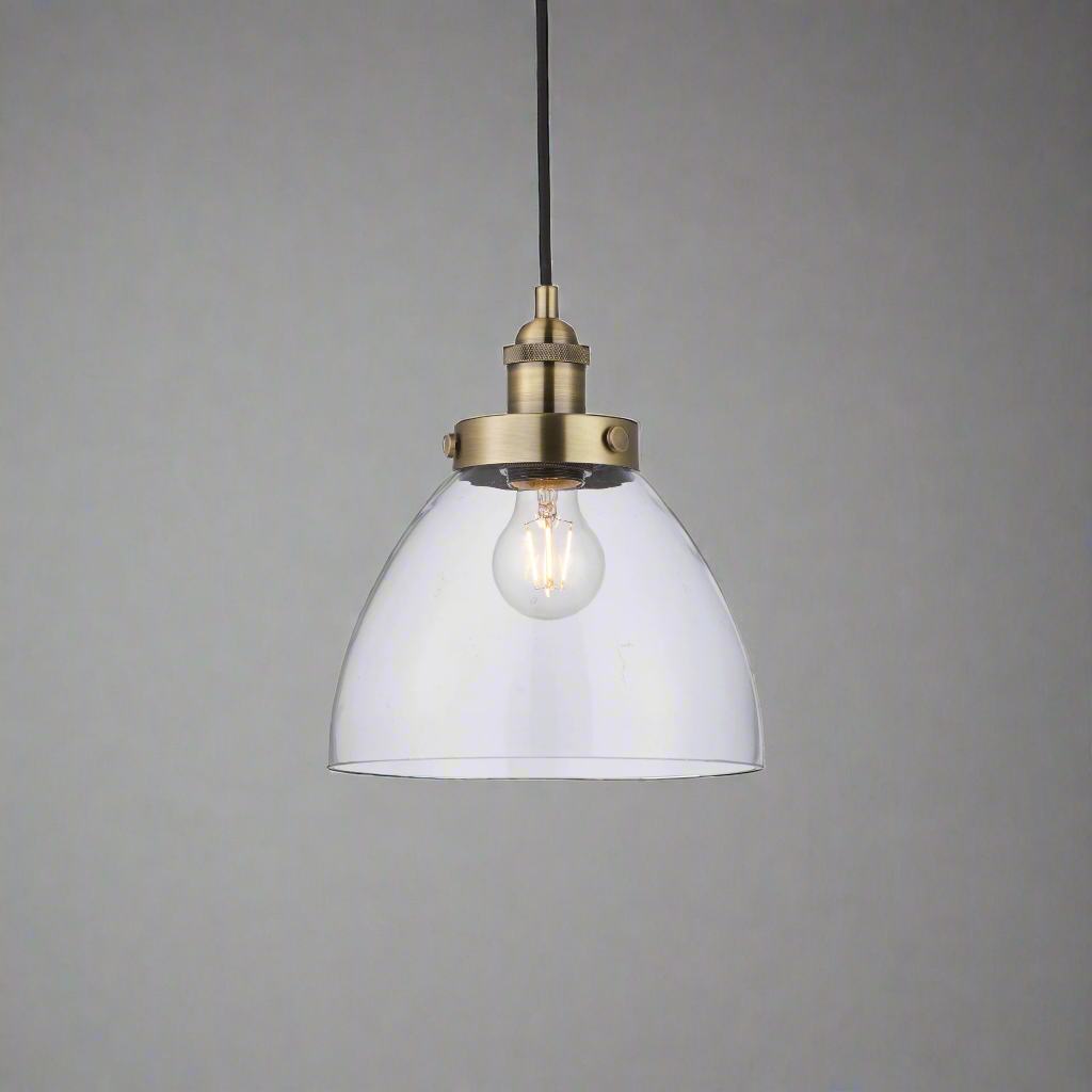 A simple glass and antique brass pendant, clean, simple lines. Great kitchen island light, either alone or in a group.