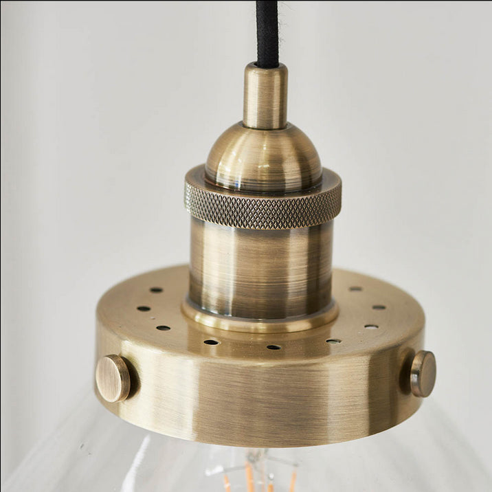 A simple glass and antique brass pendant, clean, simple lines. Great kitchen island light, either alone or in a group.