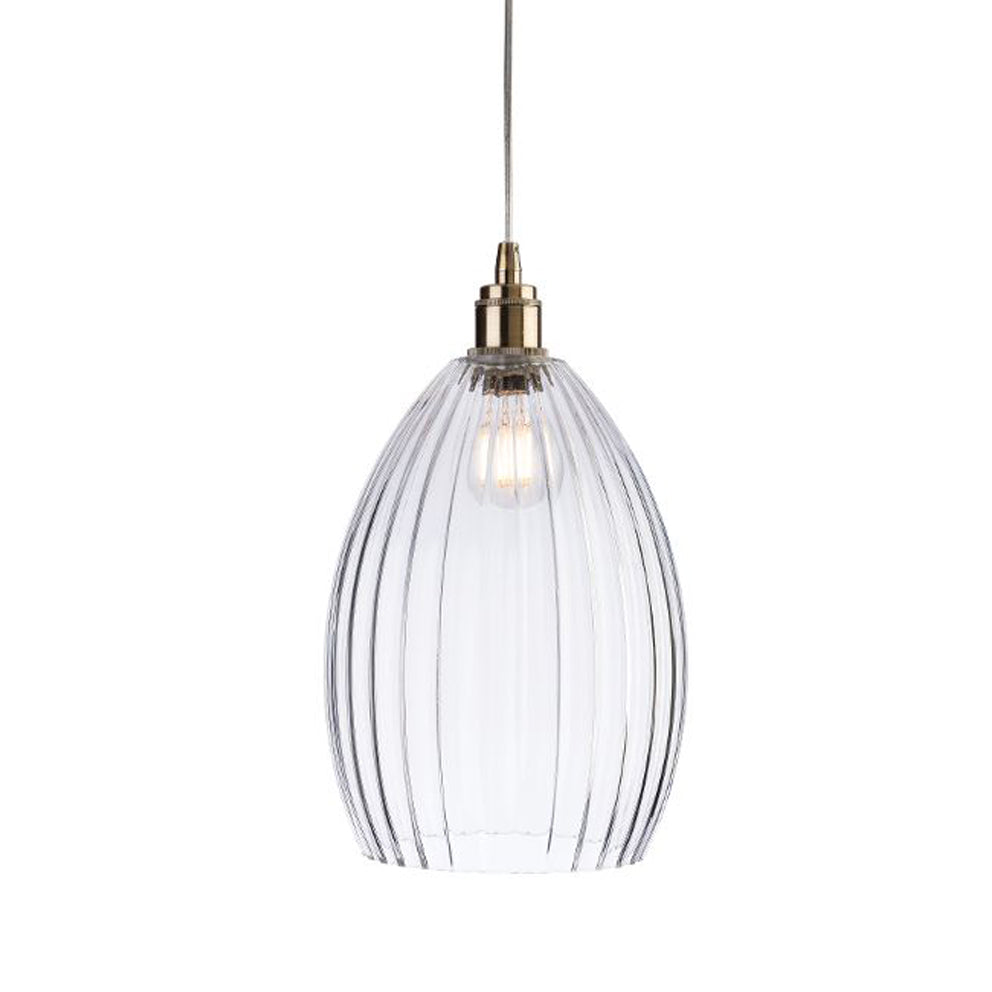 A long ribbed glass and antique brass metal pendant light. Perfect kitchen island light, or in a bedroom. Great in a hall will illuminate and add a glow to any room.