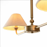 A refined ceiling light featuring an antique brass frame with two gently curved arms, each supporting a classic tapered fabric shade. Ideal over dining tables, kitchen islands, or breakfast bars