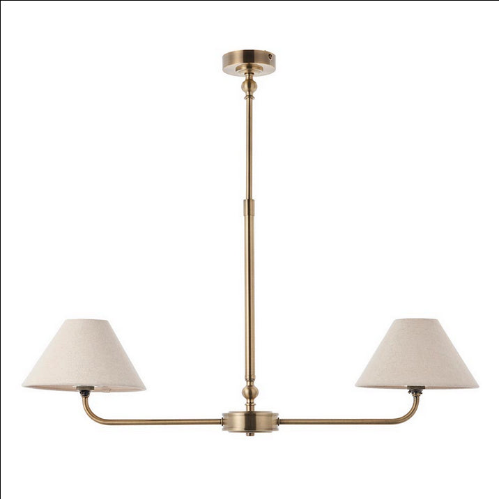 A refined ceiling light featuring an antique brass frame with two gently curved arms, each supporting a classic tapered fabric shade. Its elegant symmetry and warm metallic finish bring understated sophistication to any space.
Ideal over dining tables, kitchen islands, or breakfast bars where focused yet ambient lighting is needed. Its slim linear form makes it perfect for narrower spaces or areas requiring balanced illumination.