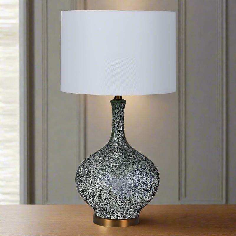 Tall, faux, antique shagreen lamp and white shade.&nbsp; A stunning contrast between the dark shagreen colour of the base and the bright white of the shade, a tall imposing lamp that will add glamour and luxury to any room.&nbsp; The whole lamp is set on an antique gold base.&nbsp; The white shade will allow a lot of light to reflect through.&nbsp;&nbsp;

H: 70 cm&nbsp; W: 40 cm