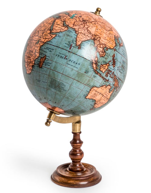 Antique rotating world globe on a wooden stand. A perfect gift for a library space.