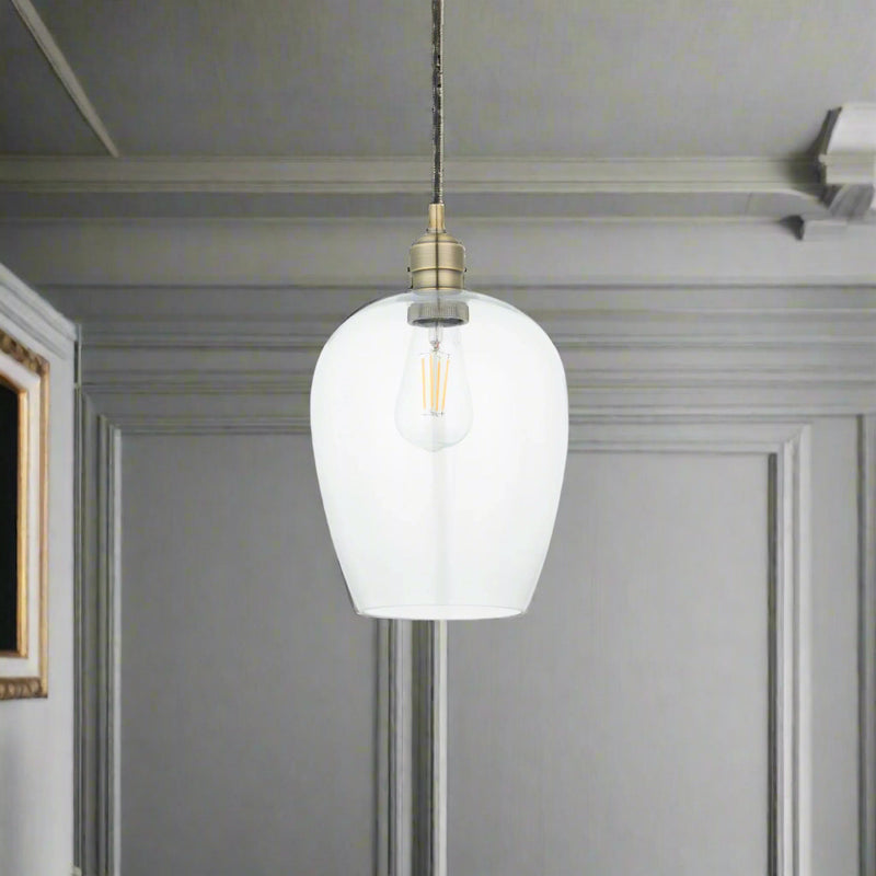 Tall clear glass pendant with brass fitting and black twisted flex.