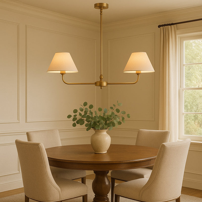 A refined ceiling light featuring an antique brass frame with two gently curved arms, each supporting a classic tapered fabric shade. Its elegant symmetry and warm metallic finish bring understated sophistication to any space.
Ideal over dining tables, kitchen islands, or breakfast bars where focused yet ambient lighting is needed. Its slim linear form makes it perfect for narrower spaces or areas requiring balanced illumination.